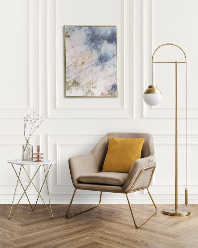 Picture frame by a velvet armchair